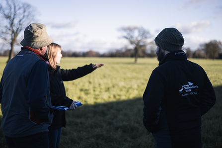 Wildlife trust staff talking with farmer - land owner